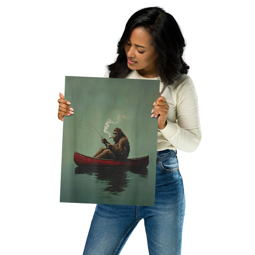 Woman holding a poster of bigfoot fishing in a red canoe.