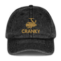 Front view of the black Cranky vintage dad hat featuring a distressed fishing reel design.